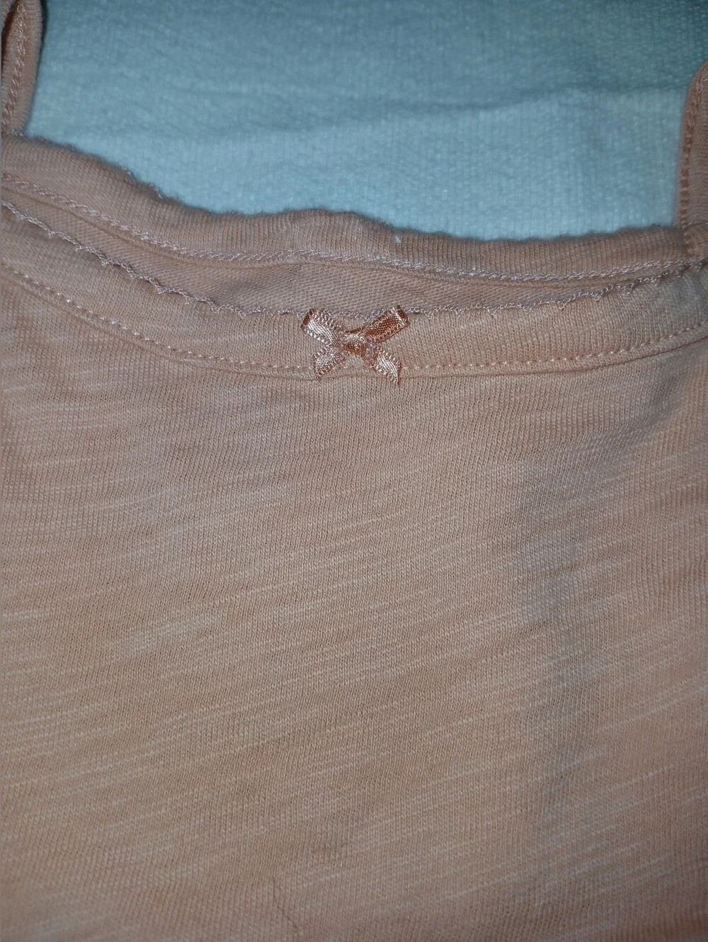 NWOT Sleeveless Peach Baby One-Piece Bodysuit.
